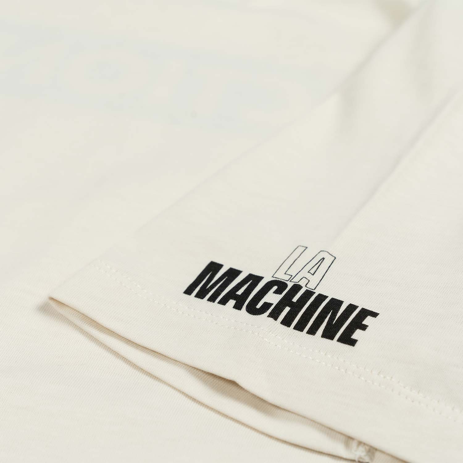 Faction La Machine Logo Tee Off-White Flat Lay Front